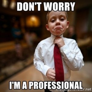 Meme of a child dressed with a tie and the caption, Don't worry.... I'm a professional